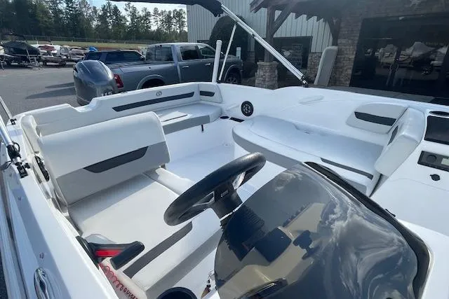 Slide: The Image of 2023 Hurricane SunDeck Sport 185 OB boat interior with seating and steering wheel. - 6