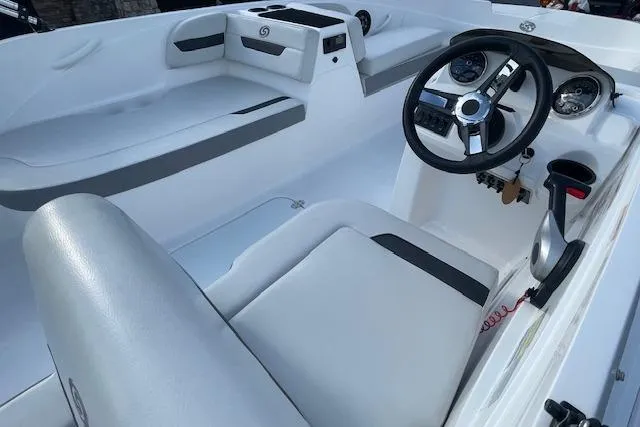 Slide: The Image of 2023 Hurricane SunDeck Sport 185 OB boat interior with steering wheel and seating. - 7