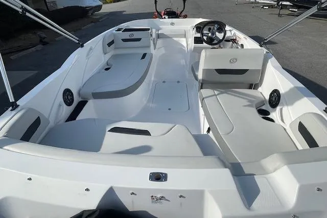 Slide: The Image of 2023 Hurricane SunDeck Sport 185 OB boat interior with seating and steering wheel. - 9
