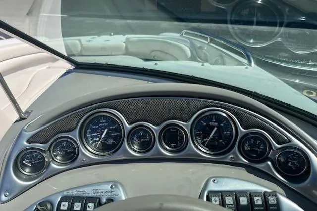 Slide: The Image of Dashboard of a 2005 Crownline 240 EX boat with gauges and controls. - 10