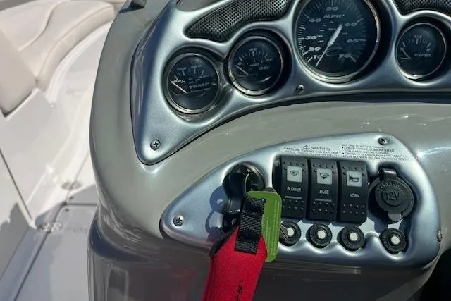 Slide: The Image of Dashboard of a 2005 Crownline 240 EX boat with gauges and switches. - 12