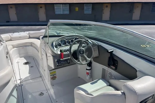 Slide: The Image of 2005 Crownline 240 EX boat interior with steering wheel and dashboard controls. - 17