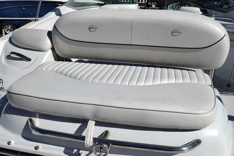Slide: The Image of Crownline 240 EX 2005 boat seat with white upholstery and chrome accents. - 19