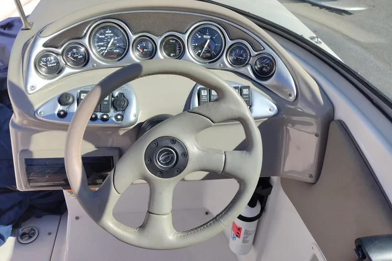 Slide: The Image of Dashboard of a 2005 Crownline 240 EX boat with steering wheel and gauges. - 21