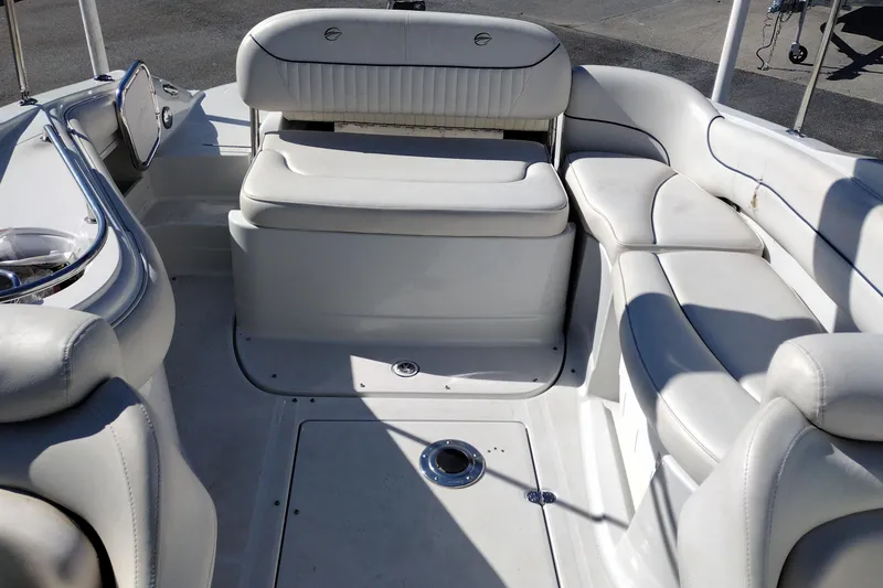 Slide: The Image of 2005 Crownline 240 EX boat interior with white seating and spacious layout. - 23