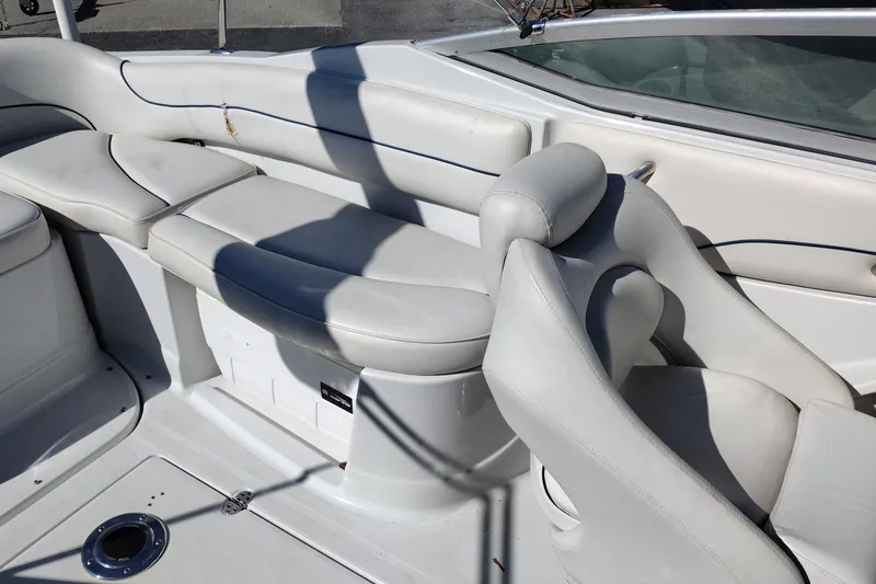 Slide: The Image of Interior seating of a 2005 Crownline 240 EX boat, featuring white cushioned seats. - 24