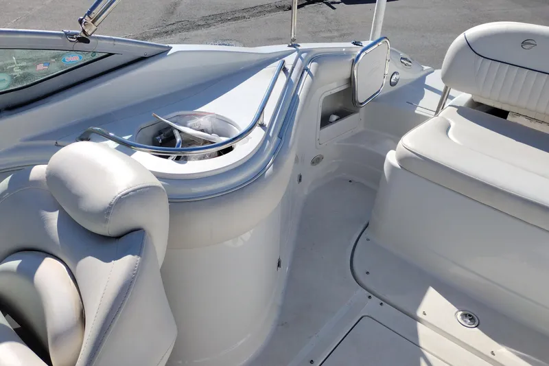 Slide: The Image of 2005 Crownline 240 EX boat interior with white seating and built-in storage. - 25
