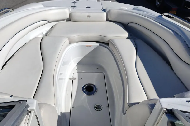 Slide: The Image of 2005 Crownline 240 EX boat interior with white cushioned seating. - 27