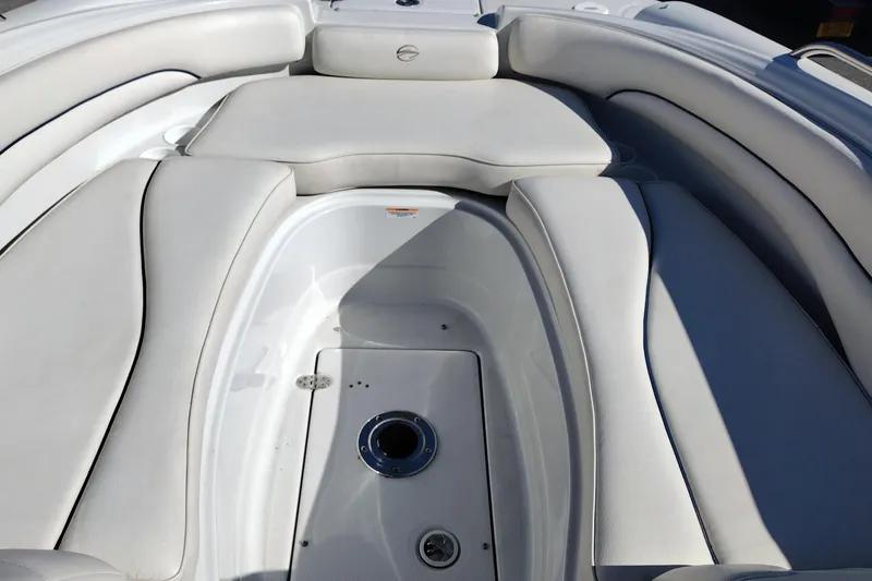 Slide: The Image of 2005 Crownline 240 EX boat interior with white cushioned seating. - 28
