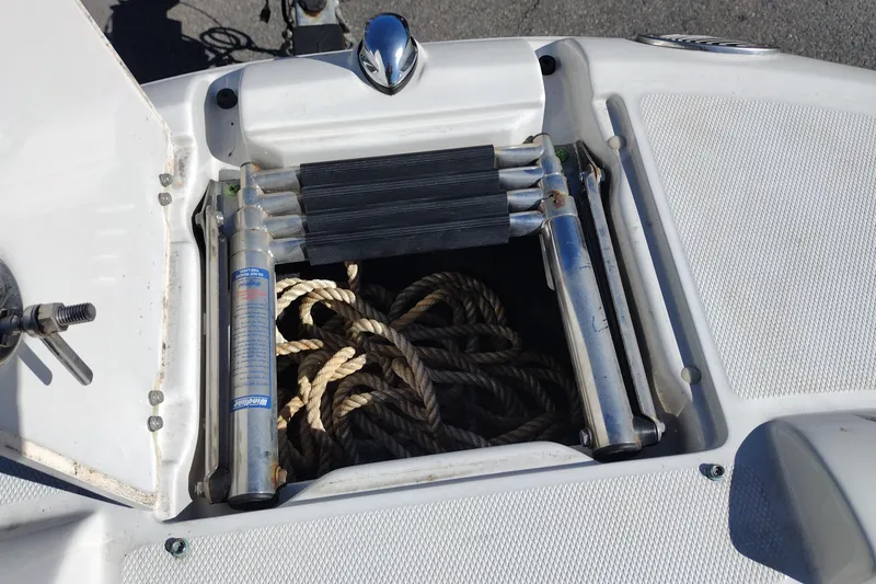 Slide: The Image of 2005 Crownline 240 EX boat ladder compartment with ropes and stainless steel fittings. - 29
