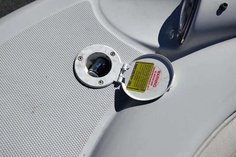 Slide: The Image of Fuel cap on a 2005 Crownline 240 EX boat with warning label. - 30