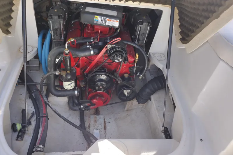 Slide: The Image of Engine compartment of a 2005 Crownline 240 EX boat, showcasing mechanical components. - 32