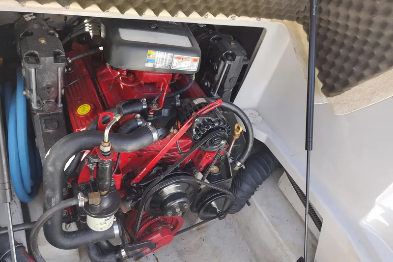 Slide: The Image of Engine compartment of a 2005 Crownline 240 EX boat, showcasing detailed mechanical components. - 33