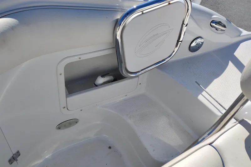 Slide: The Image of Interior view of a 2005 Crownline 240 EX boat, featuring storage compartment and seating area. - 35