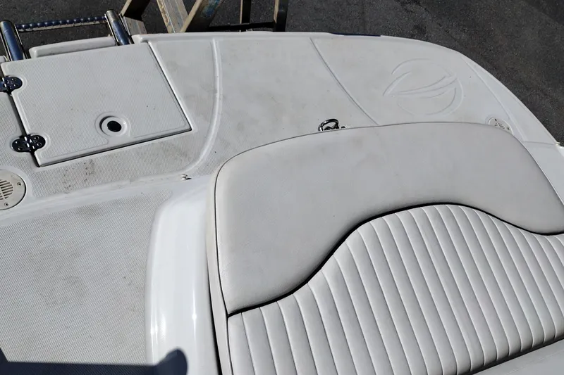 Slide: The Image of 2005 Crownline 240 EX boat deck with white cushioned seating and storage hatch. - 36