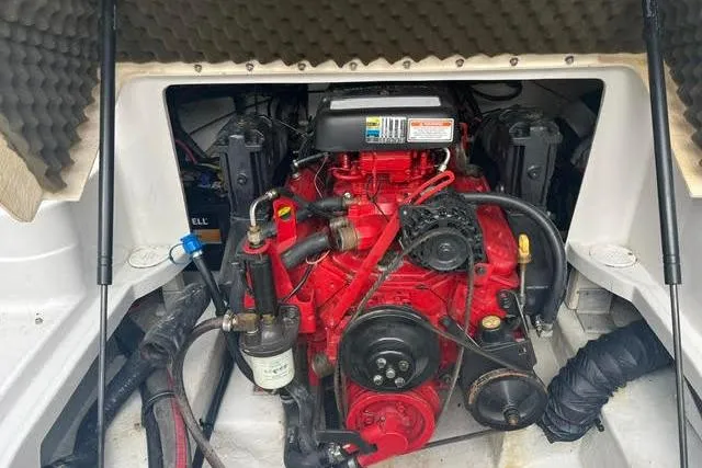 Slide: The Image of Engine compartment of a 2005 Crownline 240 EX boat, featuring a red engine. - 38