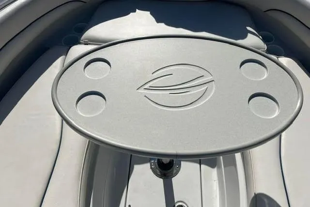 Slide: The Image of 2005 Crownline 240 EX boat interior with oval table and cup holders. - 42