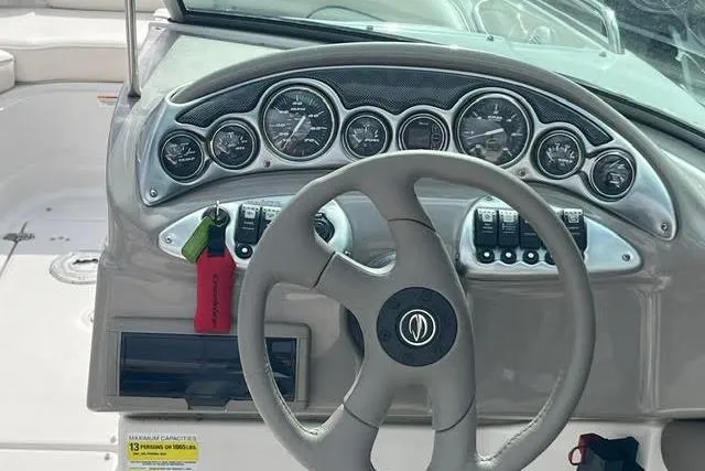 Slide: The Image of 2005 Crownline 240 EX boat dashboard with steering wheel and instrument panel. - 45