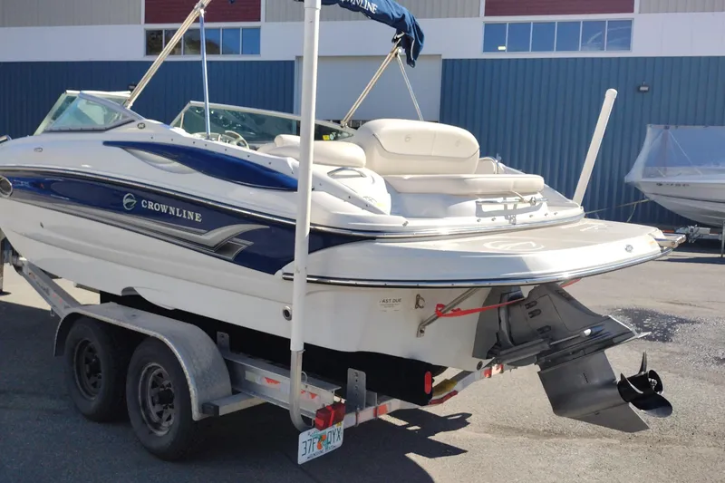 Slide: The Image of 2005 Crownline 240 EX boat on trailer, parked outdoors. - 6