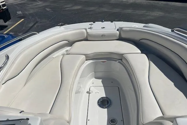 Slide: The Image of 2005 Crownline 240 EX boat interior with white cushioned seating in a spacious layout. - 9