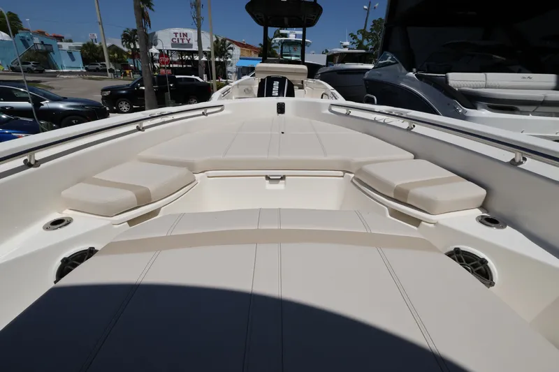Slide: The Image of The image shows the deck of a Boston Whaler 250 Dauntless with beige cushions and speakers. - 16