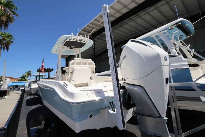 Slide: The Image of A 2027 Boston Whaler 250 Dauntless is docked. It features a large outboard motor and modern design. - 25