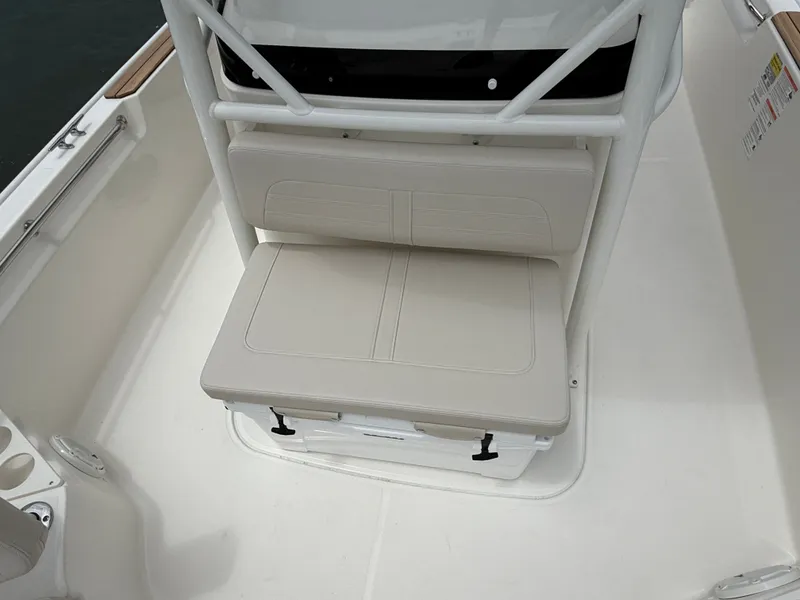 Slide: The Image of The 2026 Boston Whaler 210 Montauk features a cushioned seat with white upholstery and a sturdy frame. - 20