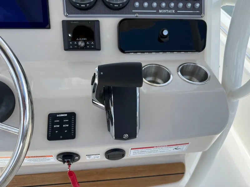 Slide: The Image of Close-up of a Boston Whaler 210 Montauk helm with controls and instruments. - 17