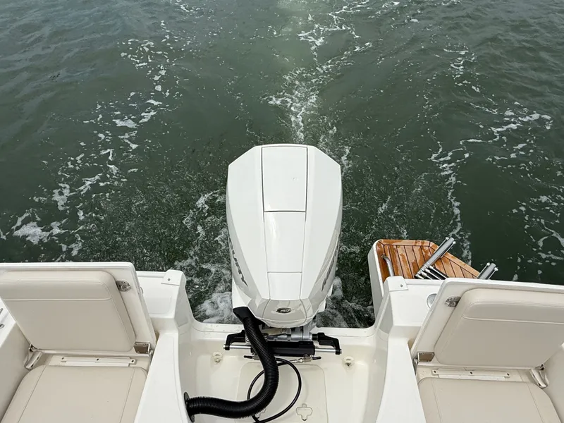 Slide: The Image of View from the stern of a Boston Whaler 210 Montauk with outboard motor and swim platform facing the water. - 8