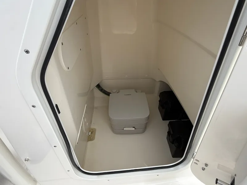 Slide: The Image of A compact toilet area with a portable toilet inside a boat. - 14