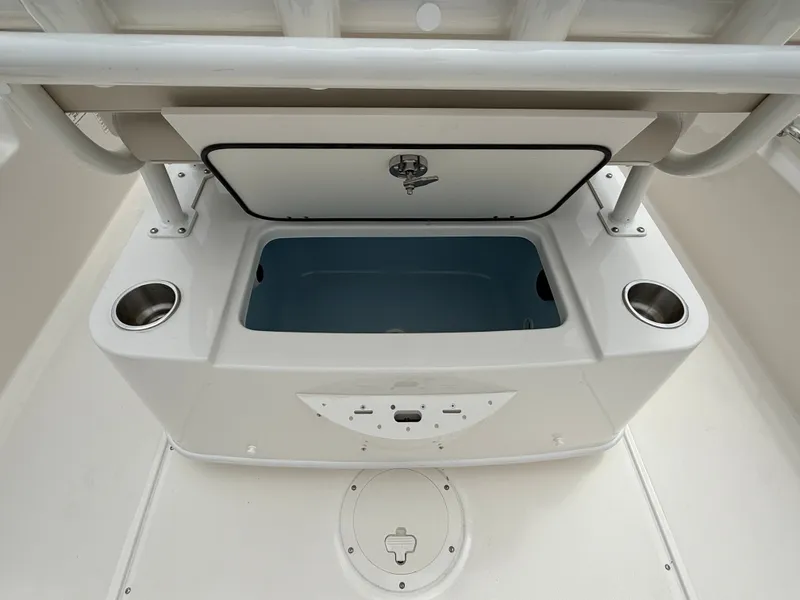 Slide: The Image of An open storage compartment with blue interior lining and two cup holders on the sides. - 13