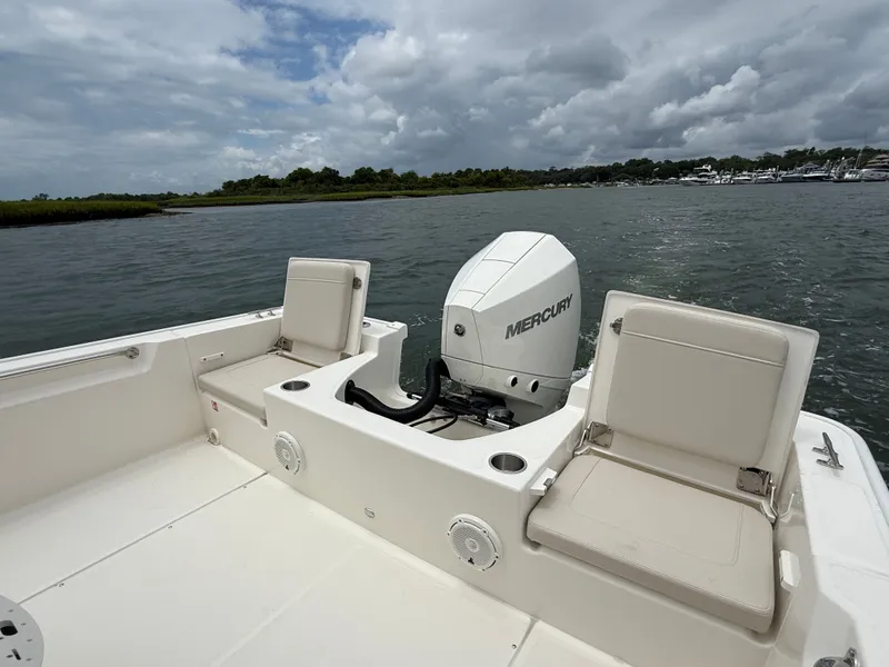 Slide: The Image of The image shows the stern of a Boston Whaler 210 Montauk with a Mercury outboard motor. - 11