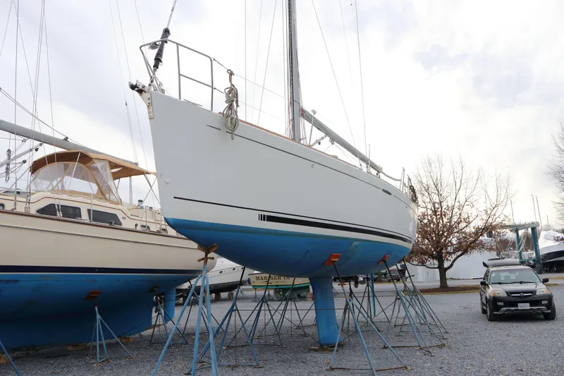 Slide: The Image of 2005 Beneteau First 47.7 sailboat on stands in a boatyard. - 0