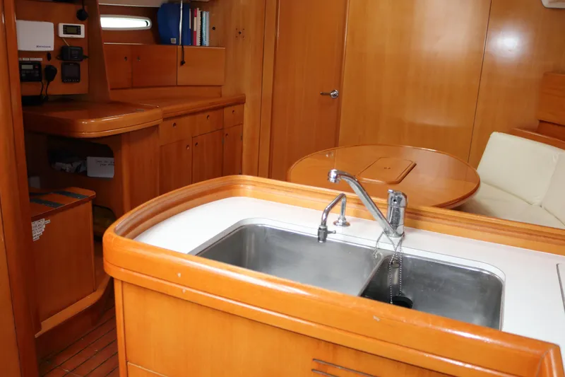 Slide: The Image of Interior of 2005 Beneteau First 47.7 yacht with wooden cabinetry and modern sink. - 10