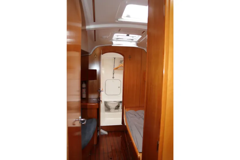Slide: The Image of Interior of 2005 Beneteau First 47.7 yacht, featuring wooden cabin and compact bathroom. - 12