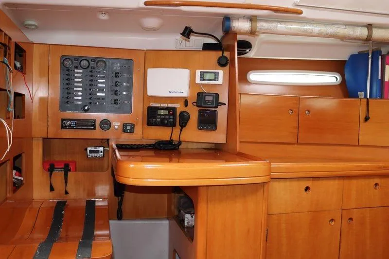 Slide: The Image of Navigation station of a 2005 Beneteau First 47.7 yacht with control panel and equipment. - 14