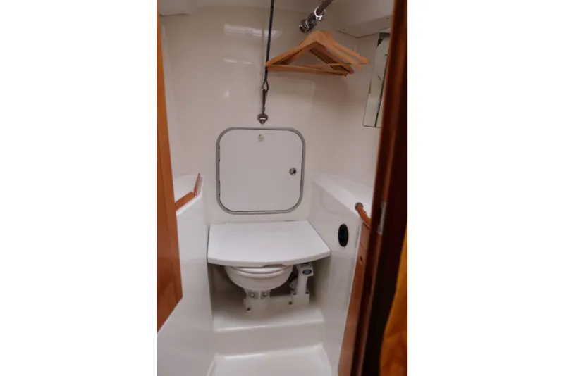 Slide: The Image of Beneteau First 47.7 2005 yacht bathroom with toilet and hanging space. - 17