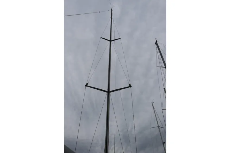 Slide: The Image of Mast of a 2005 Beneteau First 47.7 sailboat against a cloudy sky. - 5