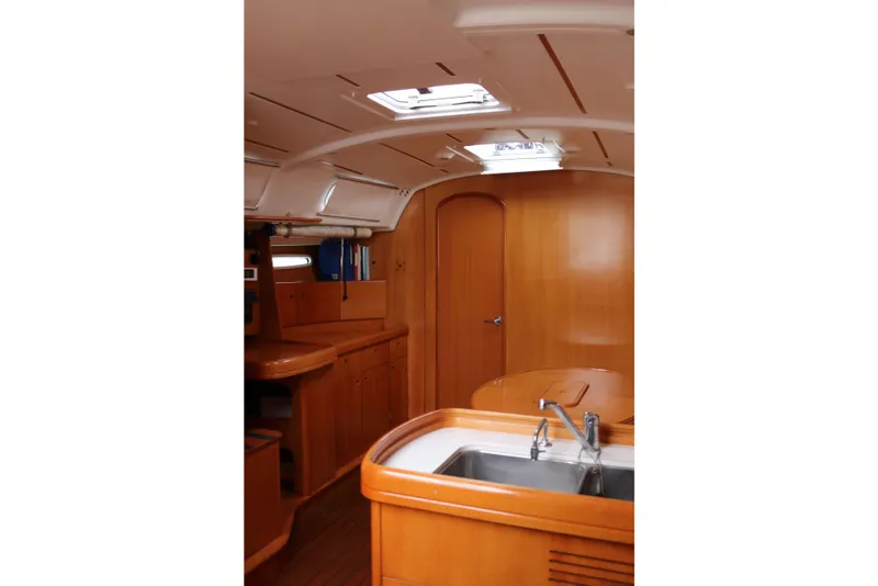 Slide: The Image of Interior of 2005 Beneteau First 47.7 yacht with wooden cabinetry and skylight. - 8