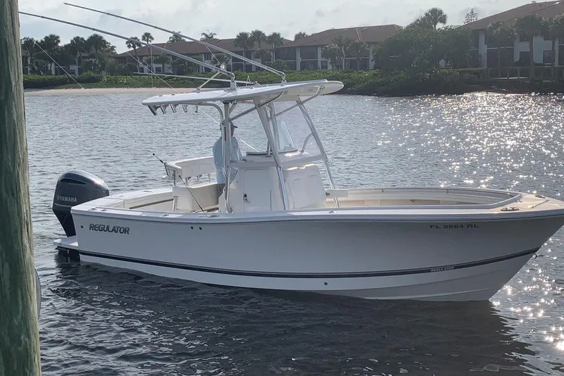 The Image of 2018 Regulator 23 Forward Seating boat on calm water, with Yamaha outboard motor. - 0