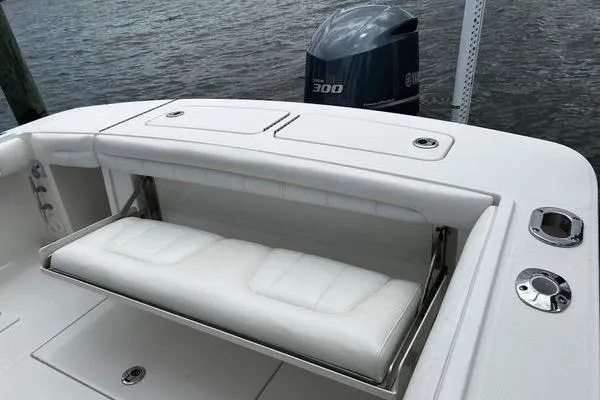 Slide: The Image of 2018 Regulator 23 Forward Seating boat with Yamaha 300 engine, featuring white cushioned seating. - 11