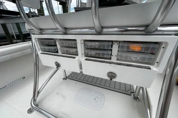 Slide: The Image of 2018 Regulator 23 Forward Seating boat storage compartments with tackle boxes. - 16
