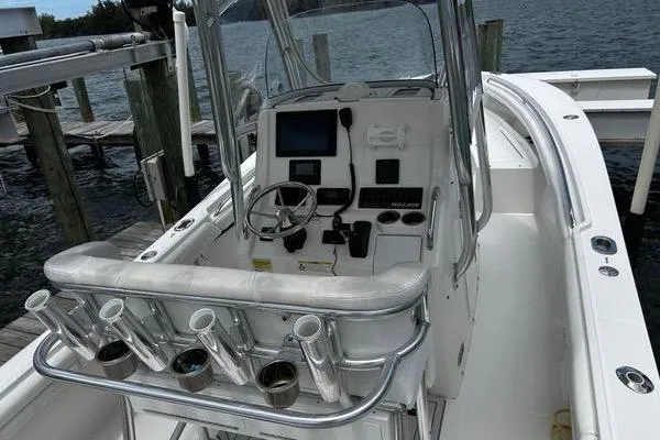 Slide: The Image of 2018 Regulator 23 Forward Seating boat with helm, rod holders, and navigation equipment. - 17