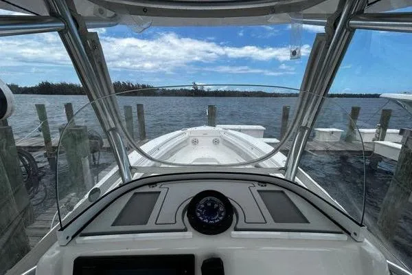 Slide: The Image of 2018 Regulator 23 Forward Seating boat docked, view from helm with clear skies. - 19