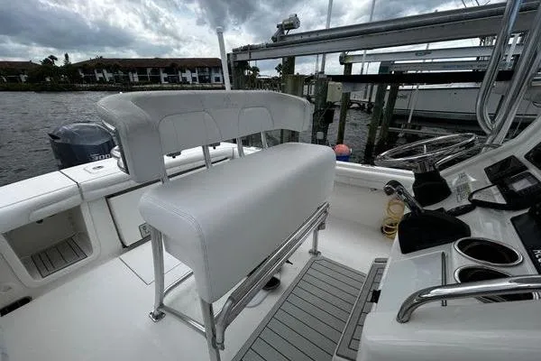 Slide: The Image of 2018 Regulator 23 Forward Seating boat interior with white seating and control panel. - 25