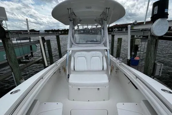 Slide: The Image of 2018 Regulator 23 Forward Seating boat docked, showcasing spacious seating and sleek design. - 26