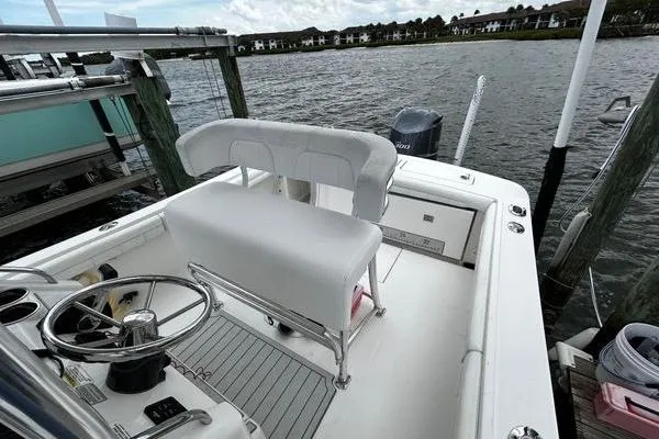 Slide: The Image of 2018 Regulator 23 Forward Seating boat docked by the water. - 27