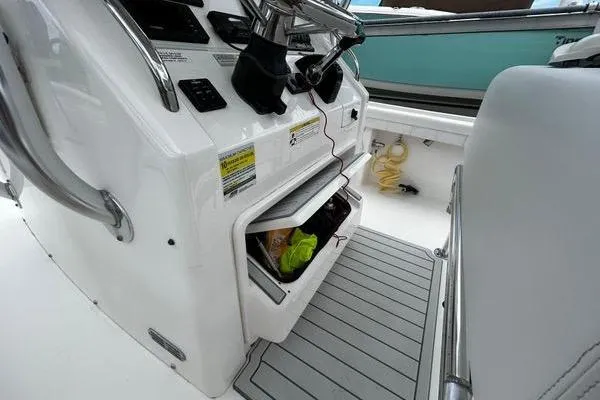 Slide: The Image of 2018 Regulator 23 Forward Seating boat console with storage compartments open. - 29
