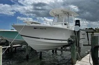Slide: The Image of 2018 Regulator 23 Forward Seating boat docked under cloudy sky. - 3