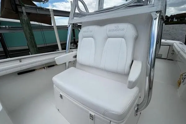 Slide: The Image of 2018 Regulator 23 Forward Seating boat with white cushioned seats and sleek design. - 30
